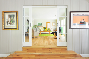 A brightly lit entryway to a living room