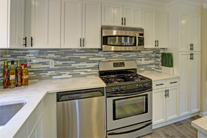 A kitchen with white cupboards