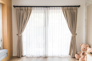 Sun shining through curtains in a bedroom